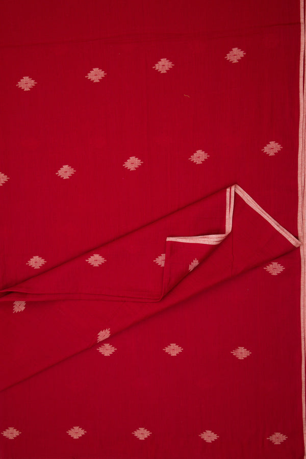 Red fabric with white floral patterns, folded and displayed.