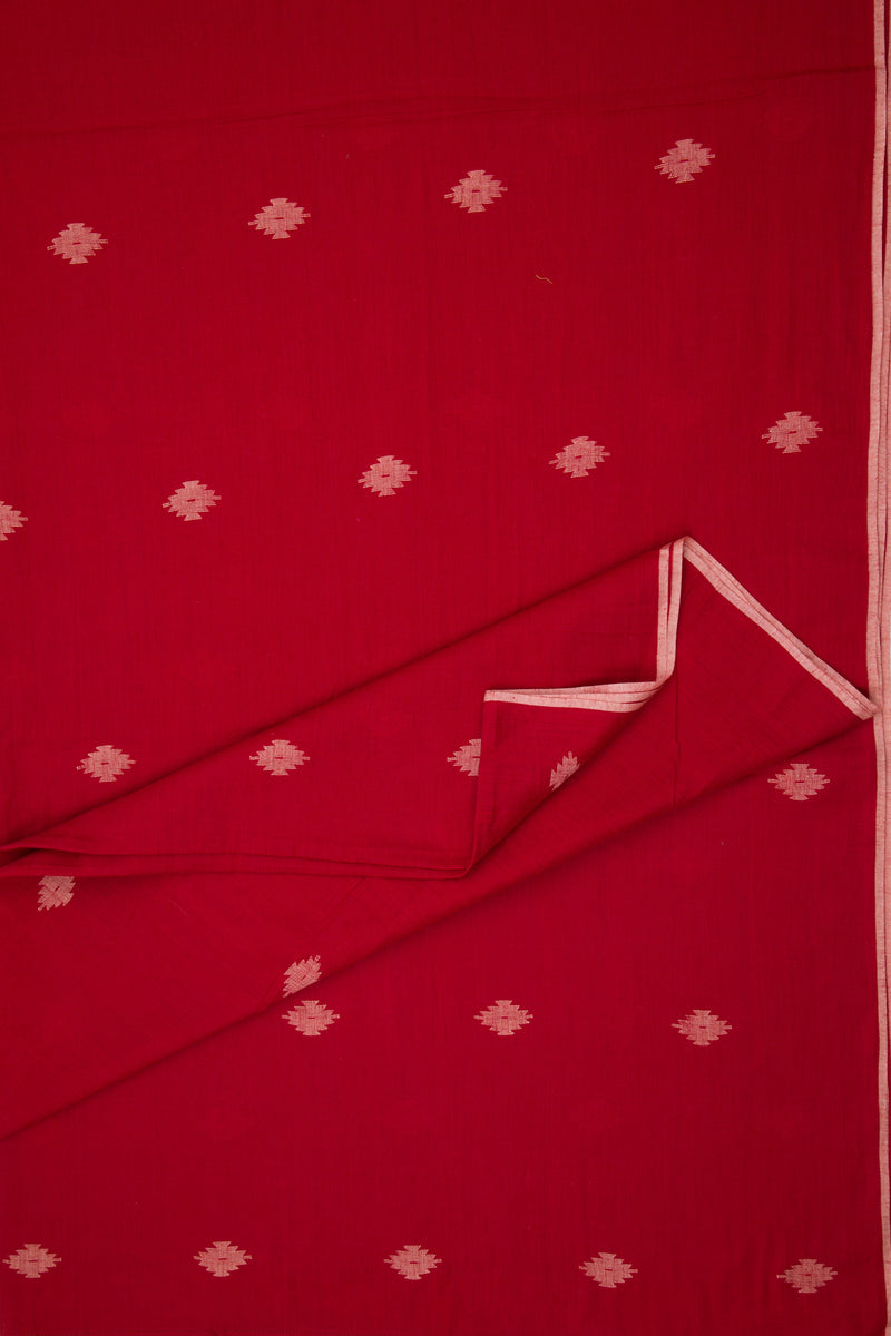 Red fabric with white floral patterns, folded and displayed.