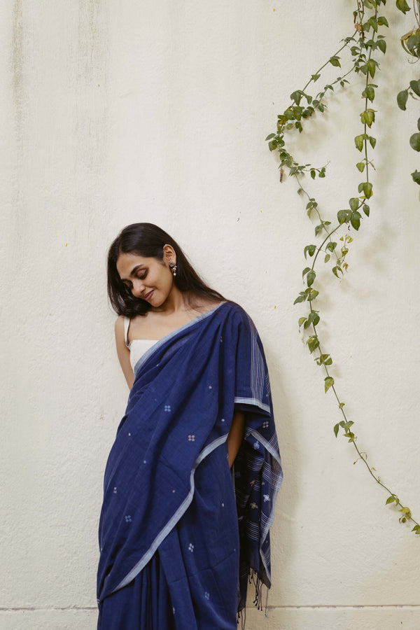 Woman wearing an indigo jamdani saree styled with grey blouse