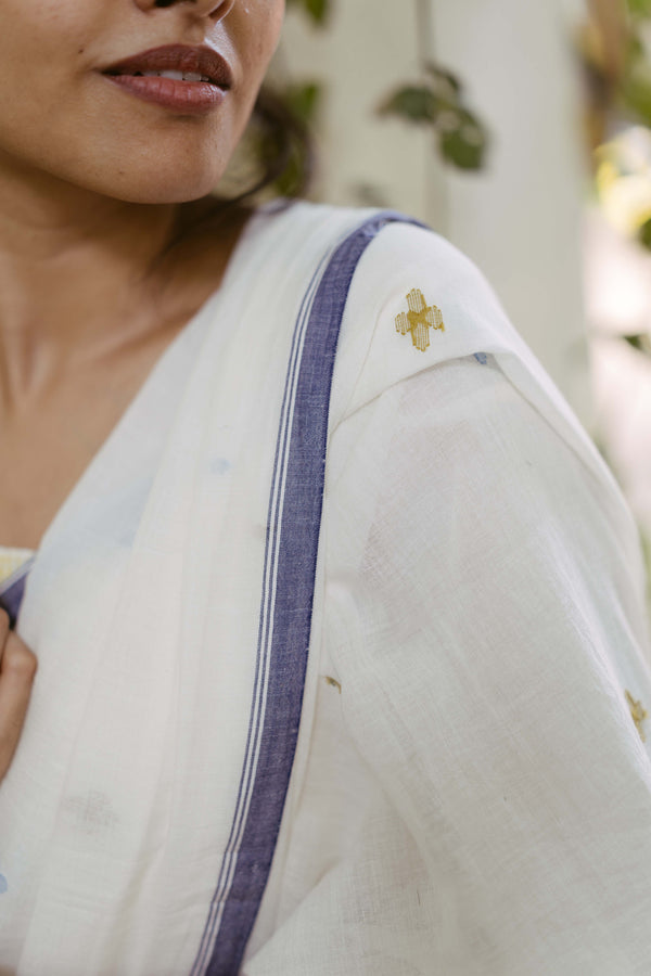 handwoven white cotton saree with yellow floral jamdani motifs closeup