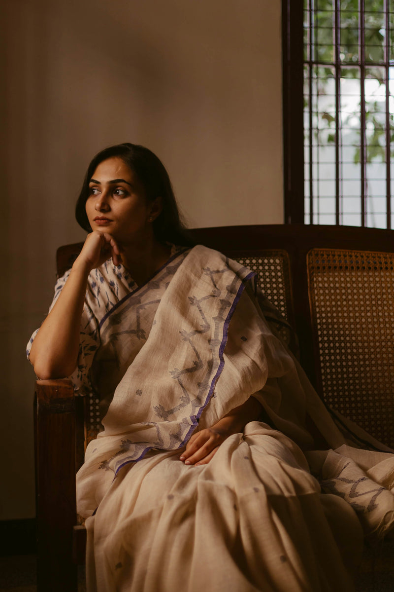 Handloom Beige & Indigo Jamdani Saree showcasing artisanal weaving.