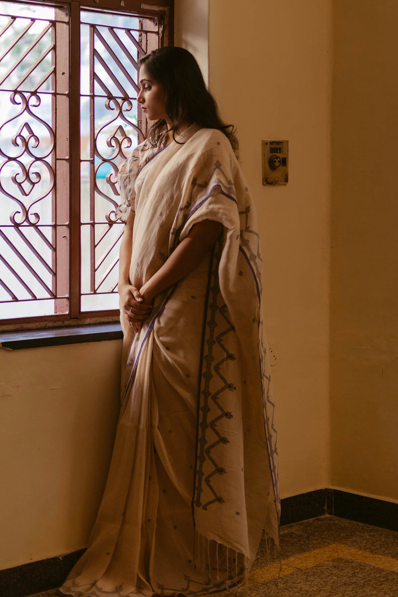 Traditional Beige & Indigo Jamdani Saree with delicate woven motifs.