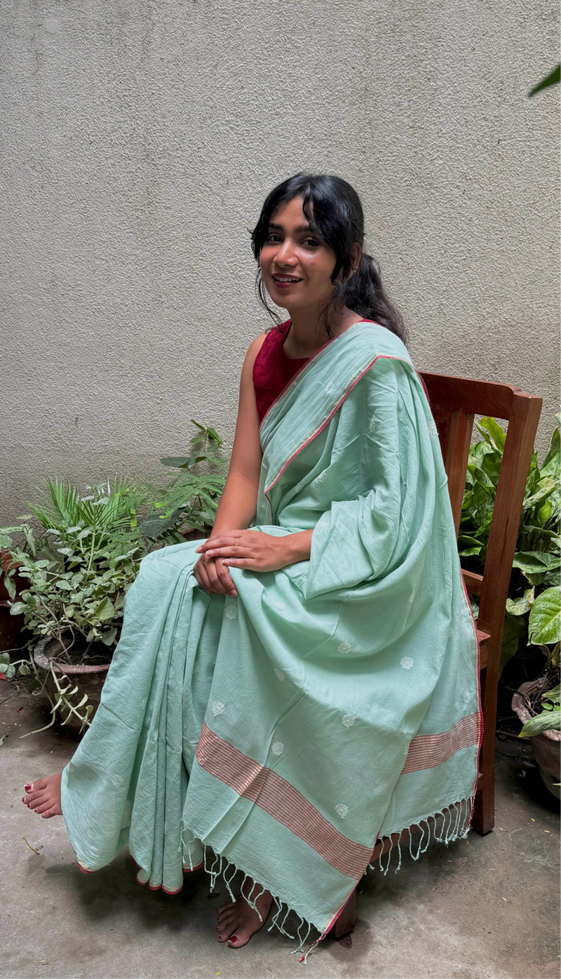 Handwoven Bengal Jamdani saree in pastel green with delicate white motifs