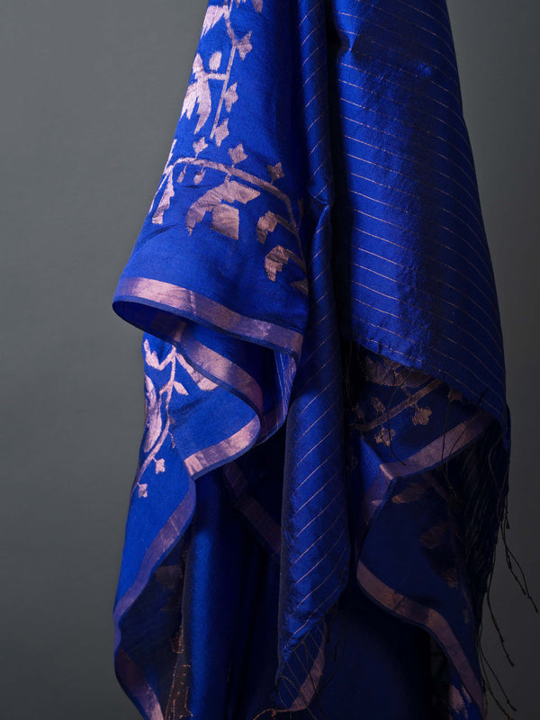 Model wearing indigo silk jamdani saree with zari motifs and contemporary pallu.