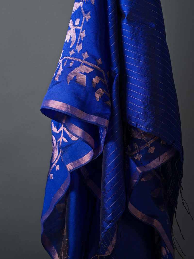 Model wearing indigo silk jamdani saree with zari motifs and contemporary pallu.