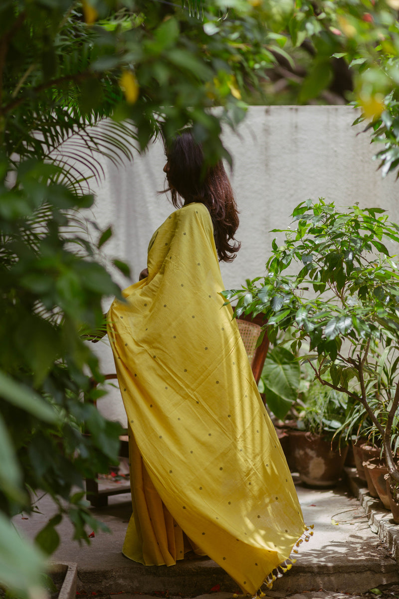 Bright yellow Khadi Jamdani saree draped elegantly, premium handloom Indian women's clothing