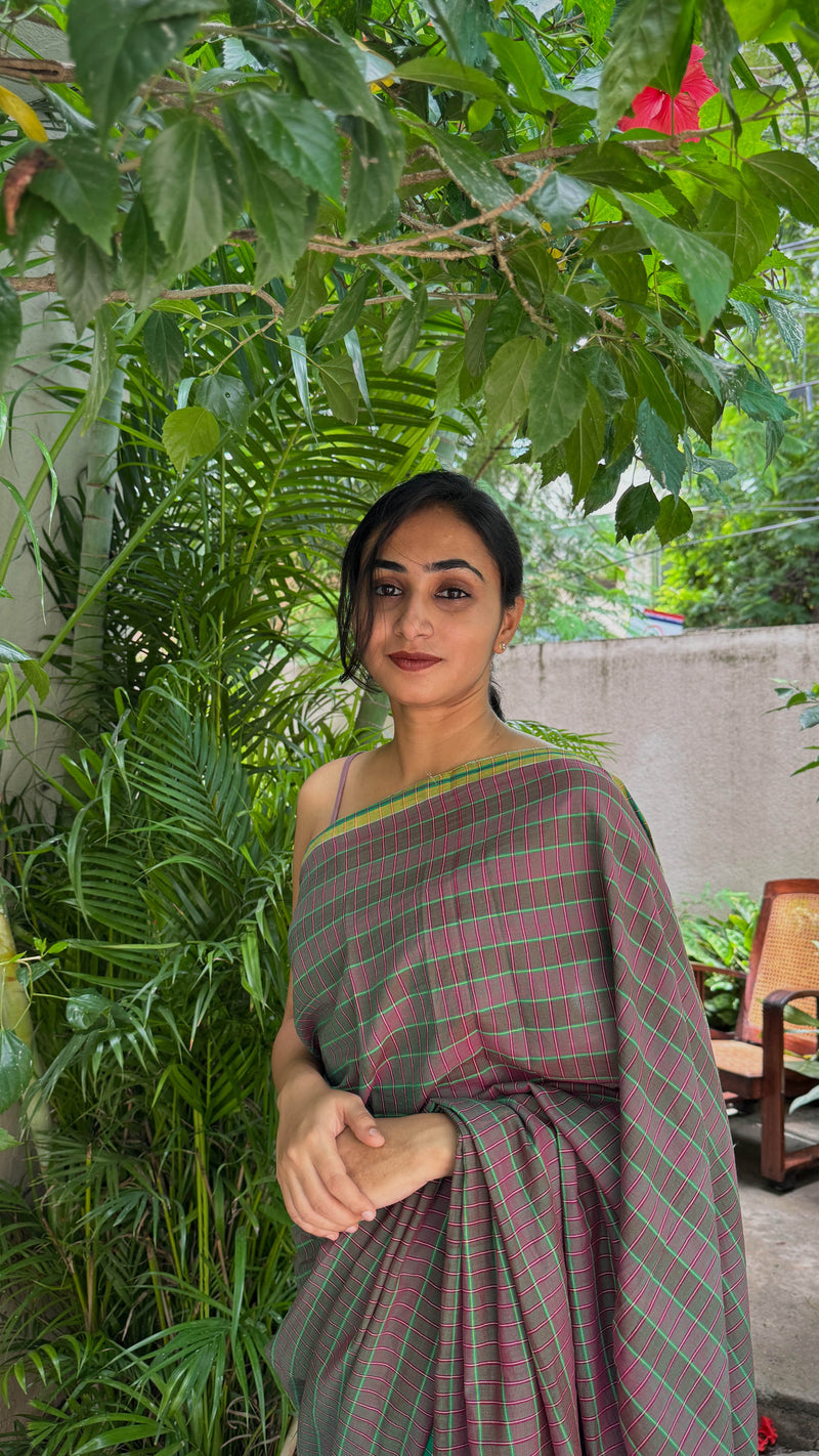 Elegant checked cotton saree with temple-style tassels and classic watch accessory