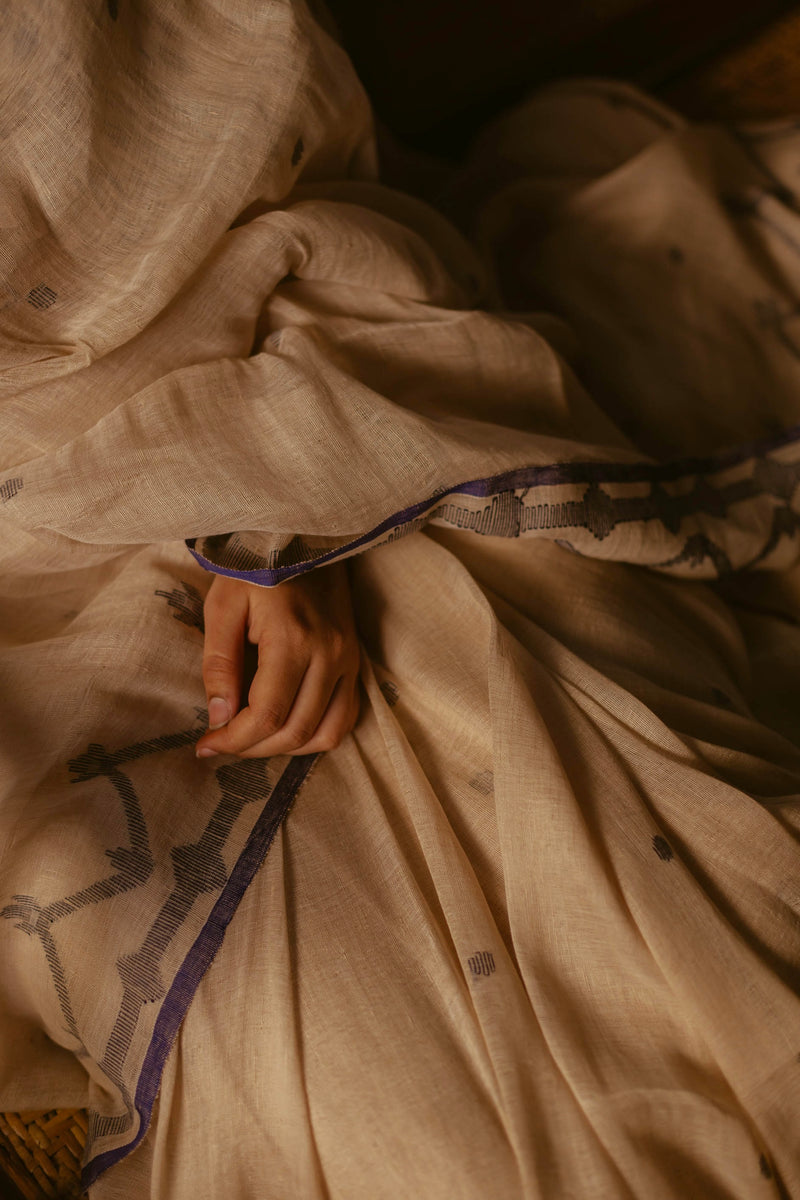 Close-up of Beige Linen Jamdani Saree with Indigo geometric border.