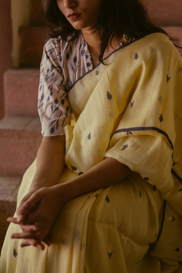 Woman wearing Lemon Yellow Linen Jamdani Saree in natural light setting