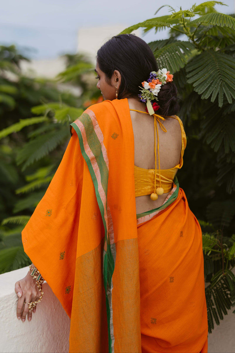 Premium orange jamdani saree with bottle green selvedge and authentic handwoven sari.