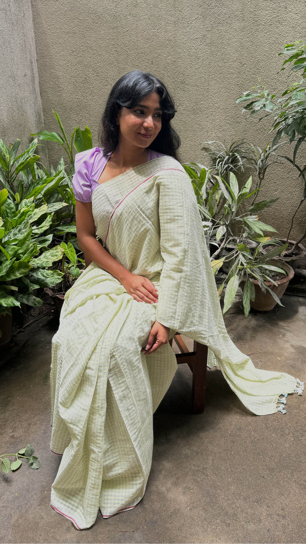 Pastel green cotton saree with subtle check pattern and contrast pink selvedge