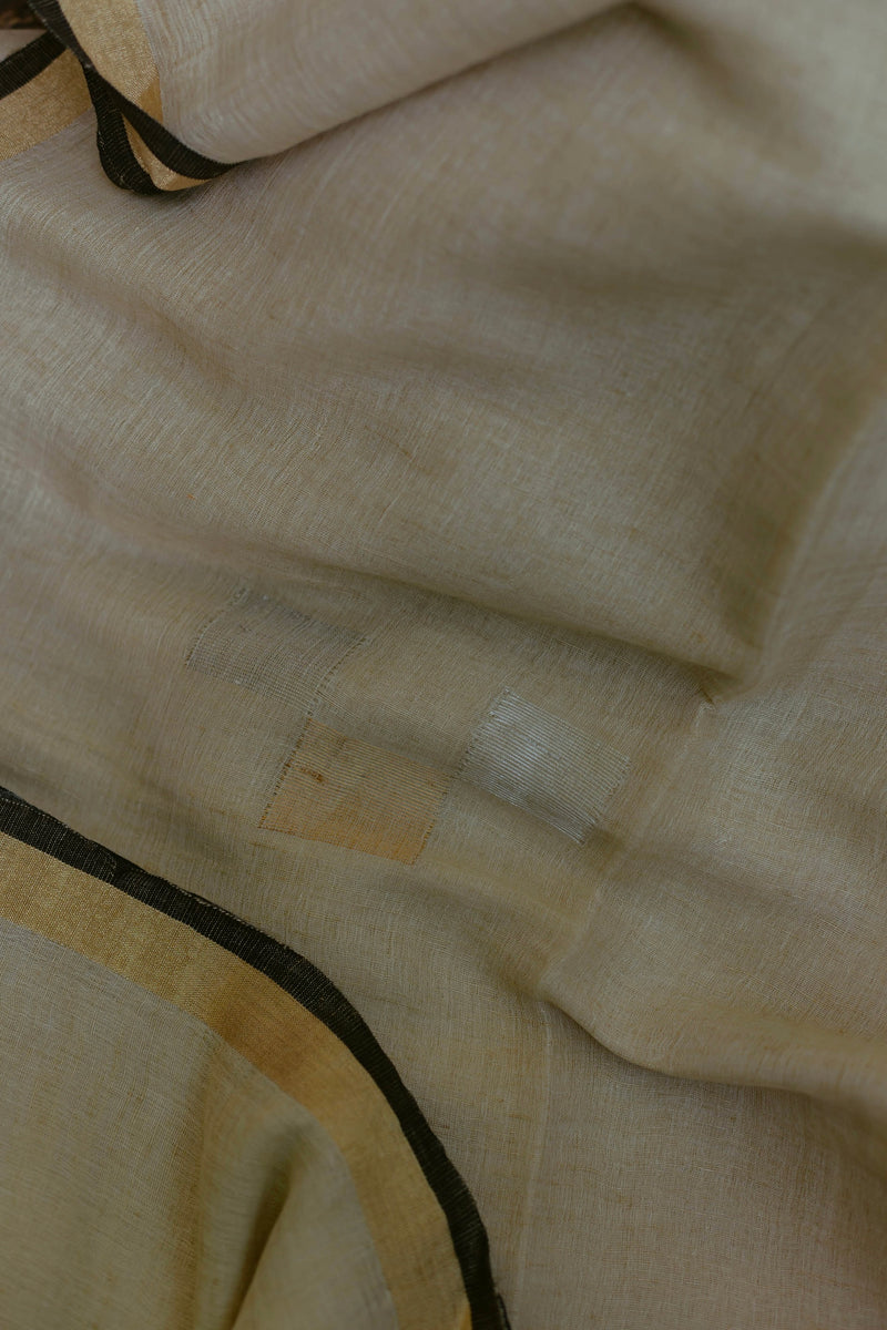 Handwoven Ivory & Gold Linen Saree featuring sleek black border, perfect for festive and elegant wear.