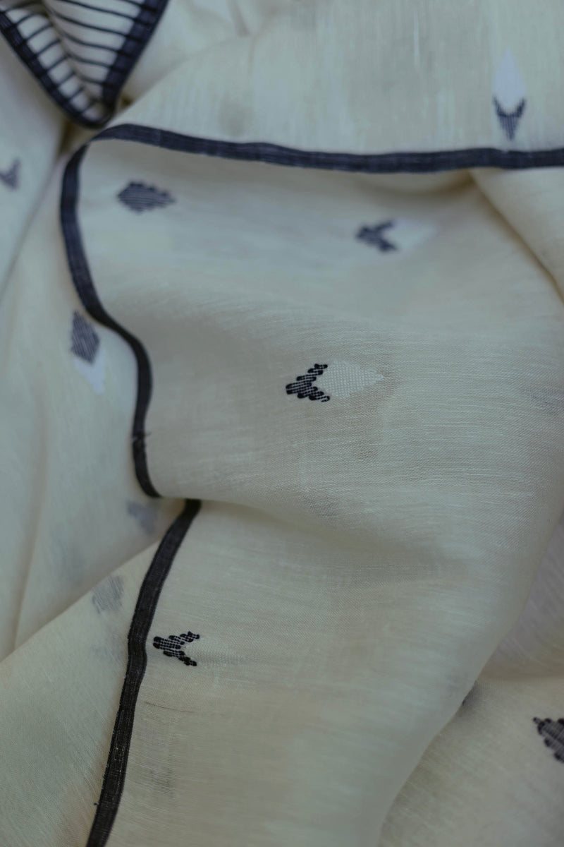 Pure linen Jamdani saree in white with indigo accents, showcasing lightweight handcrafted elegance.