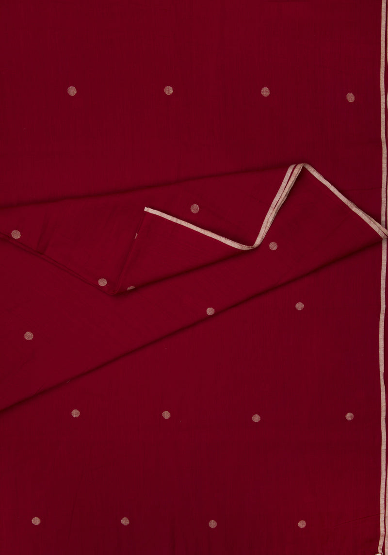 Red fabric with white polka dots  jamdani and creme selvedge 