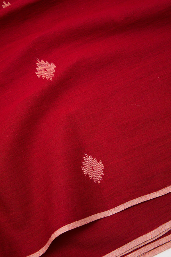 Red handwoven Jamdani fabric with traditional motifs, 70 GSM artisan textile from India.