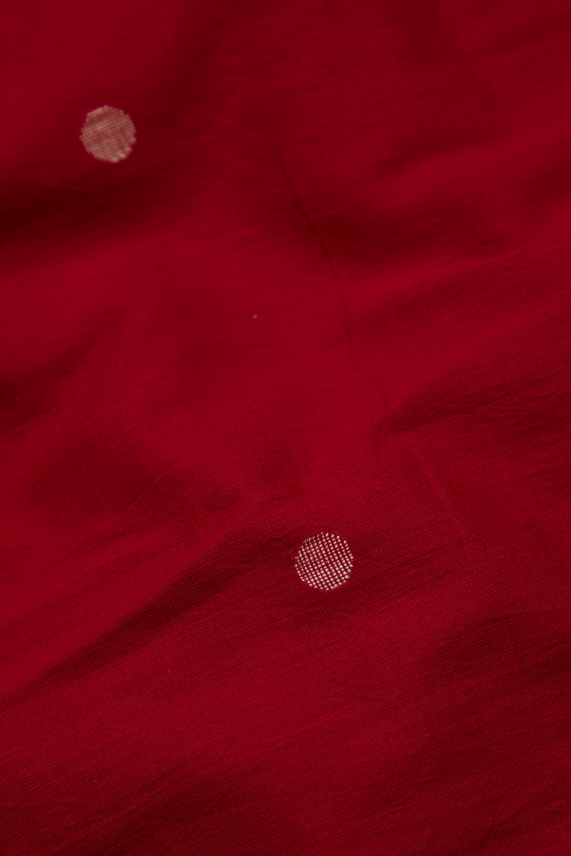 Close-up of a red fabric with jamdani motifs 