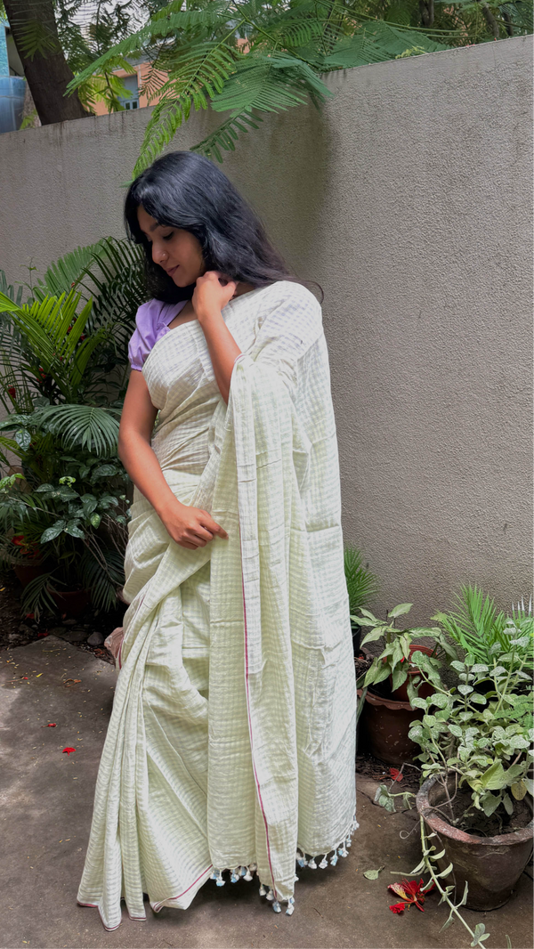 Handloom saree in soft green with fine checks and lightweight drape