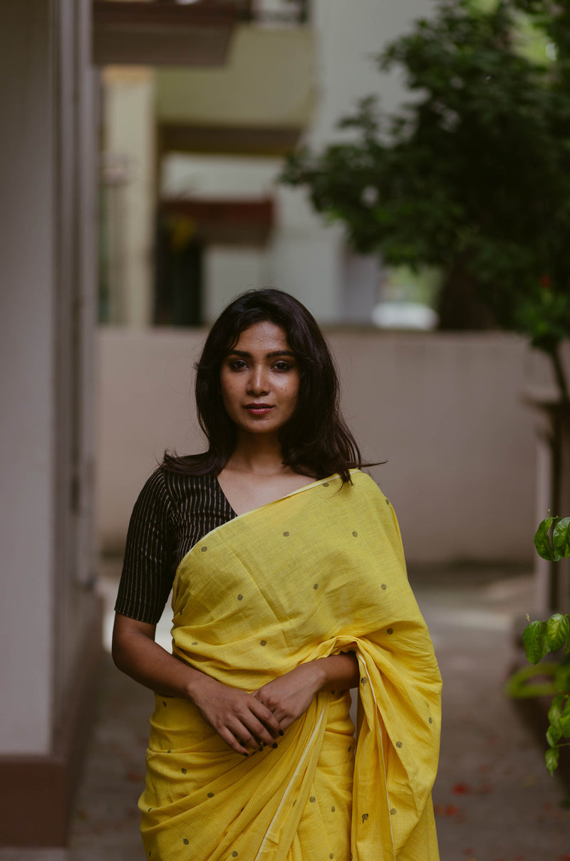 Lightweight yellow Khadi Jamdani saree with tassels, sustainable Indian artisan craftsmanship