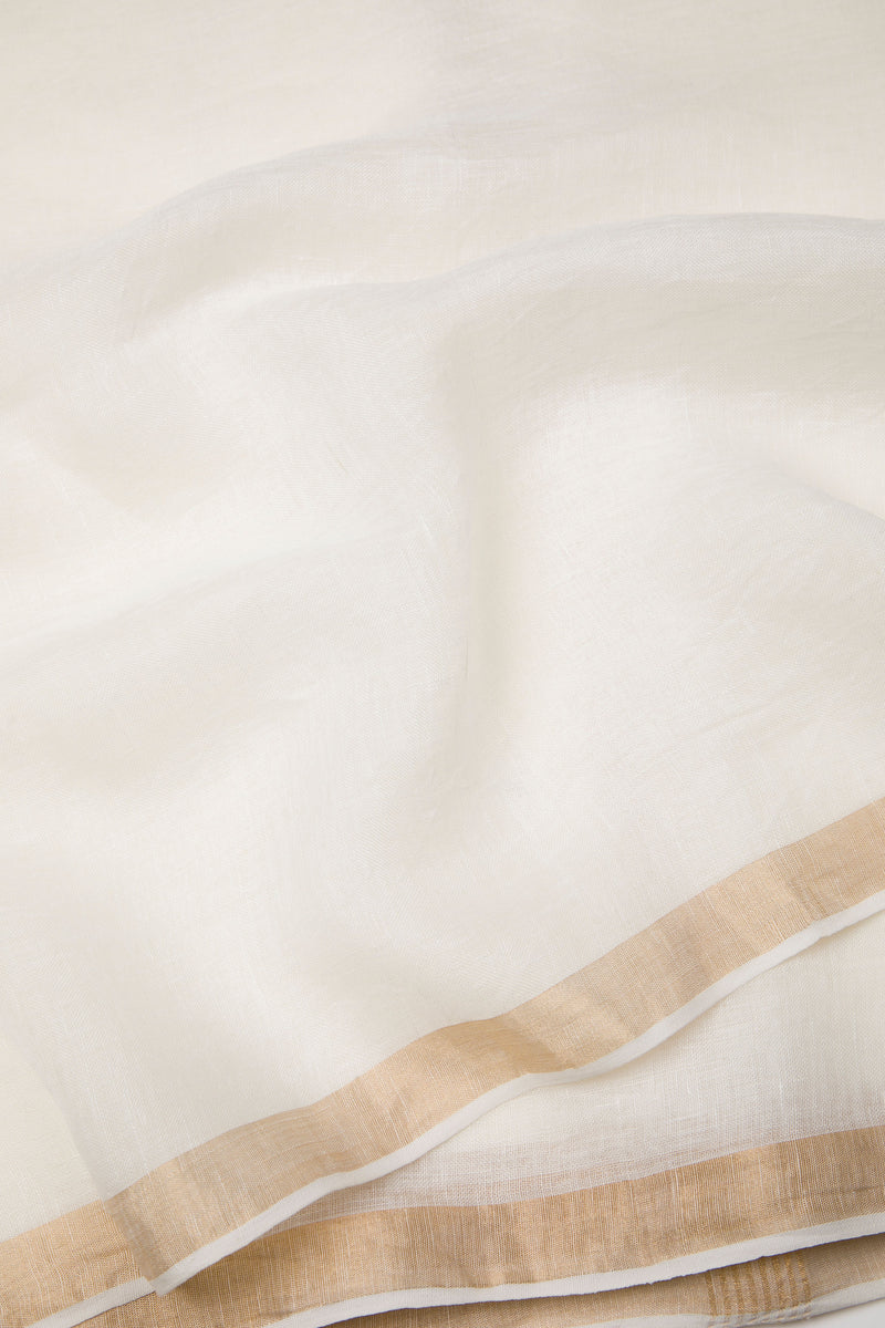 Off-white linen silk saree with golden zari border for Onam celebrations