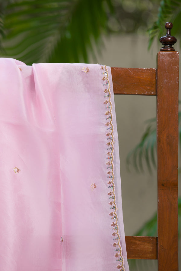 Elegant pink organza silk saree with delicate embroidery and gold border
