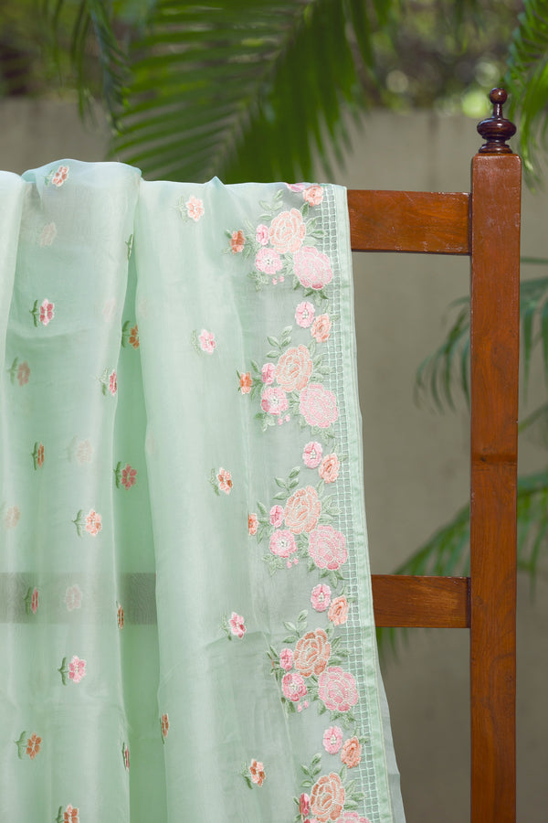 Glorious Garden Silk Organza Saree with Floral Embroidery – A close-up shot showcasing the beautiful floral embroidery on a light green silk organza saree.