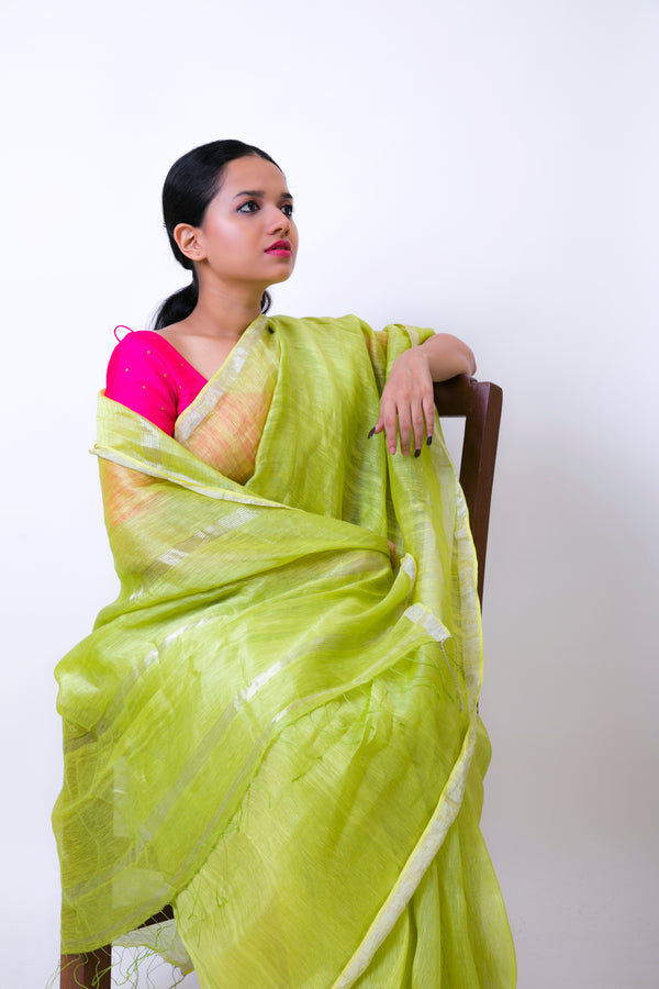 Elegant green handwoven linen silk saree with a pink blouse