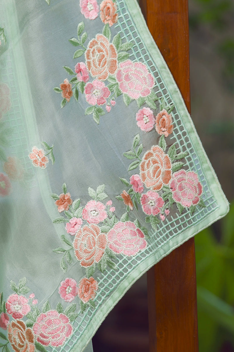 Green Silk Organza Saree with Soft Pink Floral Embroidery and Borders – Capturing the floral pattern and bordered design of a light green silk organza saree.