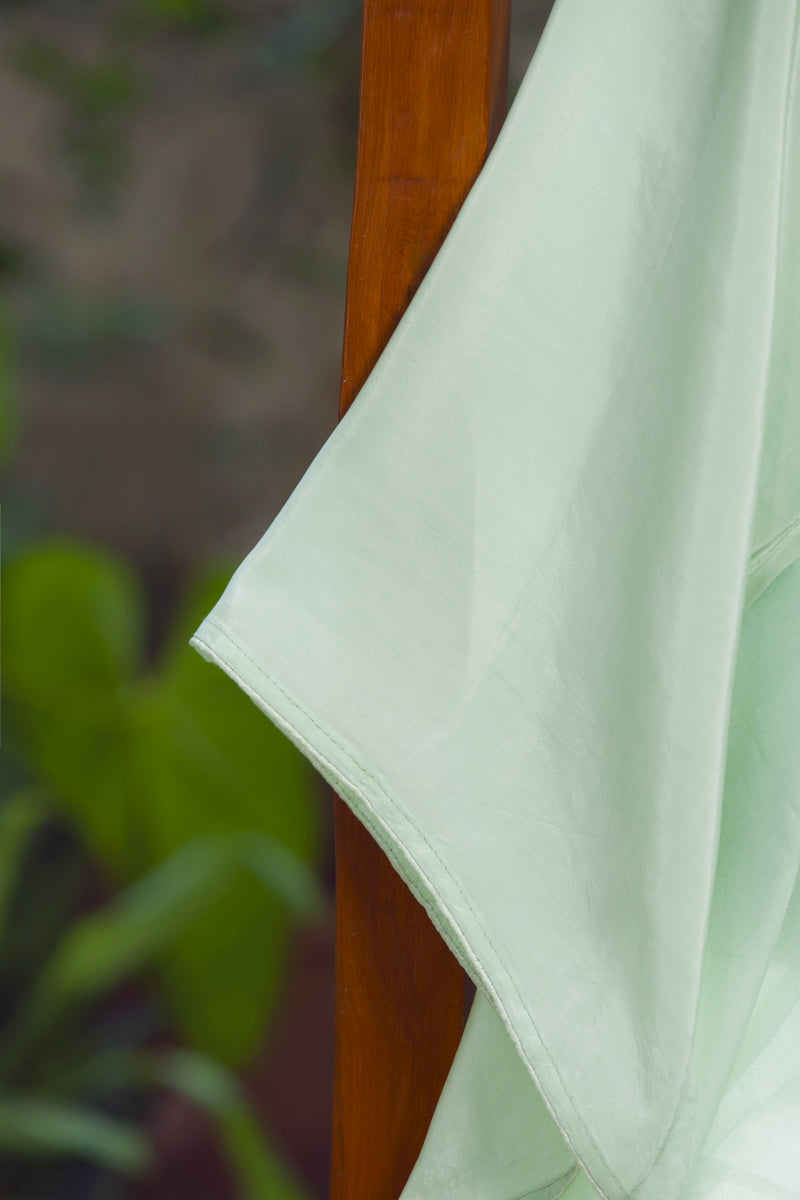 Handcrafted Green Silk Organza Saree with Rose and Floral Embroidery – Close-up shot of the handcrafted rose floral embroidery on a green silk organza saree.
