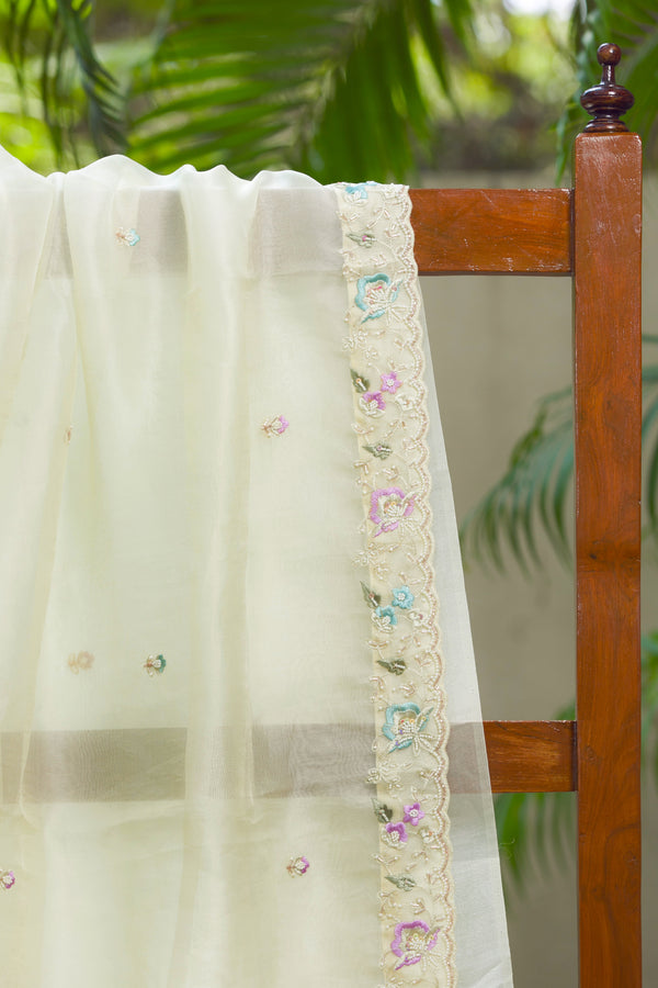 Ivory silk organza saree with pastel floral embroidered scalloped border