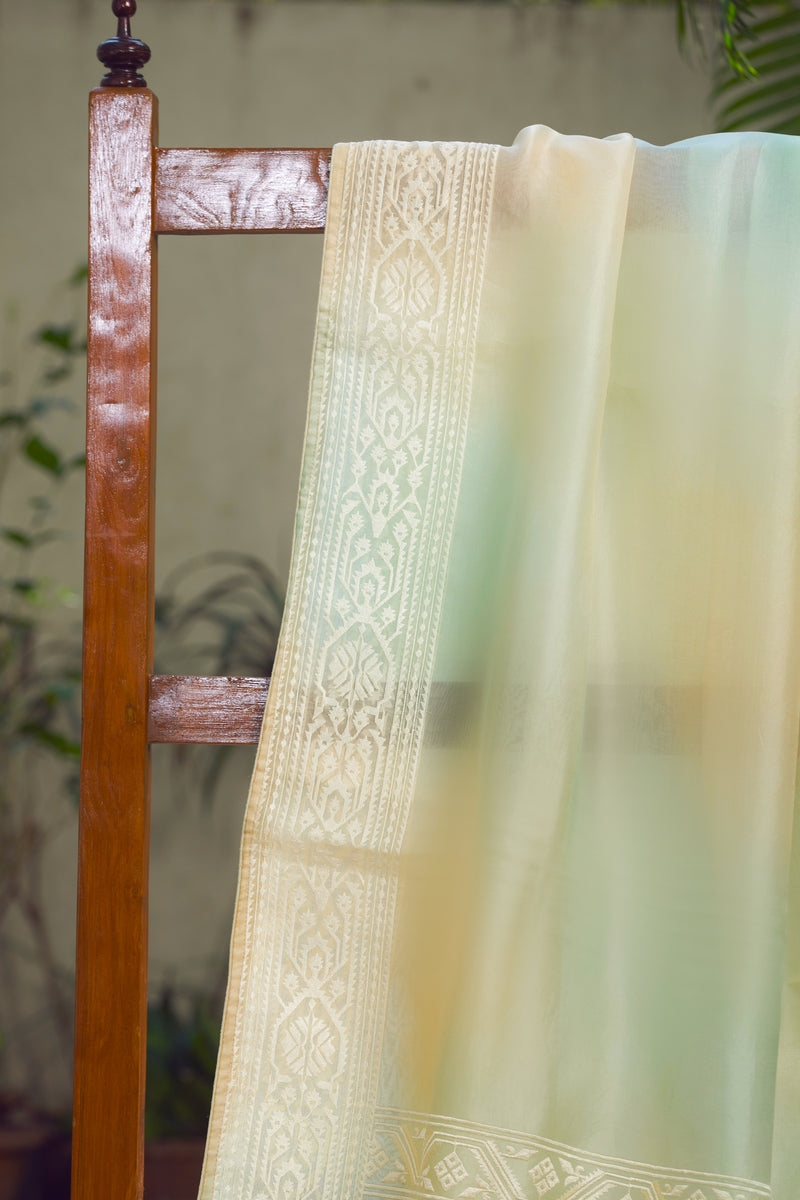 Light green and ivory organza saree with traditional Jamdani motifs