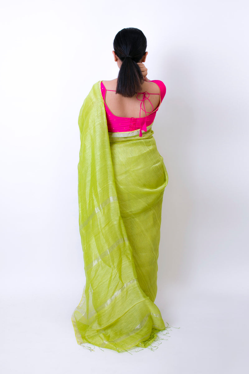 Model wearing a Gorgeous Green handwoven linen silk saree in a seated pose