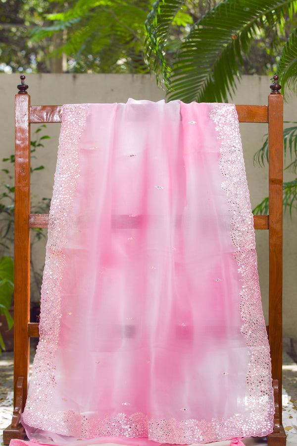 Pastel pink sheer organza sari featuring sparkling mirror butis and lace border