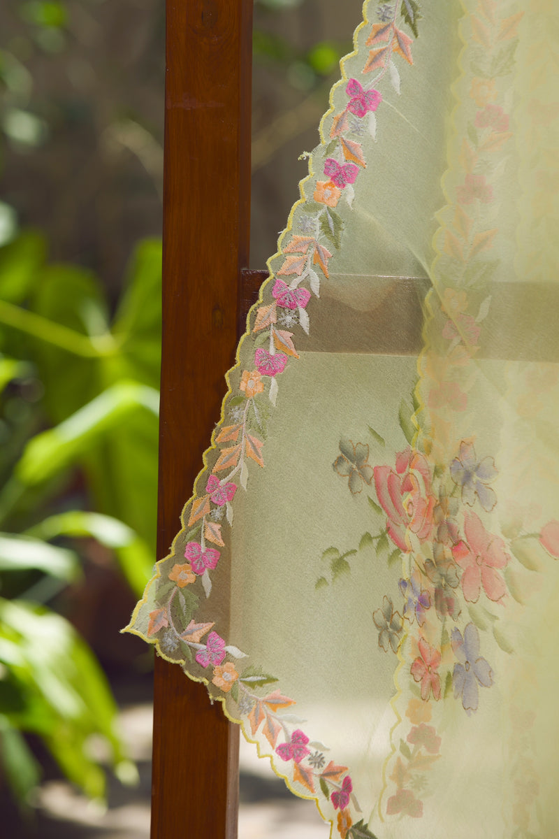 Elegant sheer silk saree with floral embroidery and pastel scalloped edges