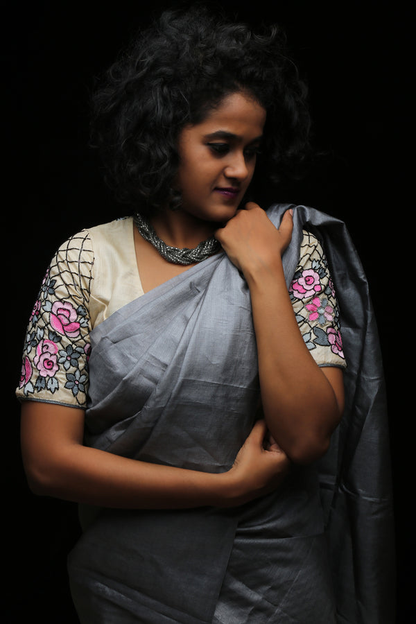 varsaaedit Secret Garden hand-embroidered champagne-gold saree blouse, front view with pink florals and grey leaves.
