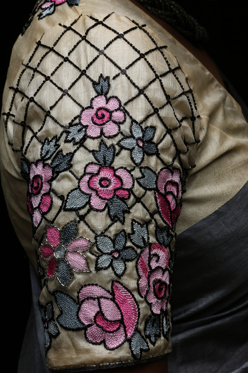 Sleeve close-up: varsaaedit Secret Garden saree blouse with pink florals, charcoal-grey leaves and black beaded lattice.